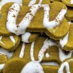 A pile of pumpkin pie dog treats shaped in dog bones.